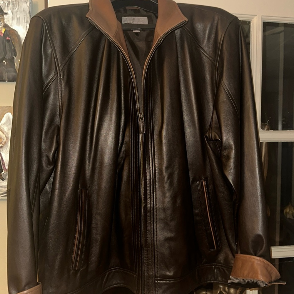 Men’s chocolate brown rich leather jacket with lighter brown accents at collar.